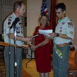 Scout Master Bill Poteet presenting son, Christopher, with Eagle Scout Certificate while Mother, Cheryl, looks on.